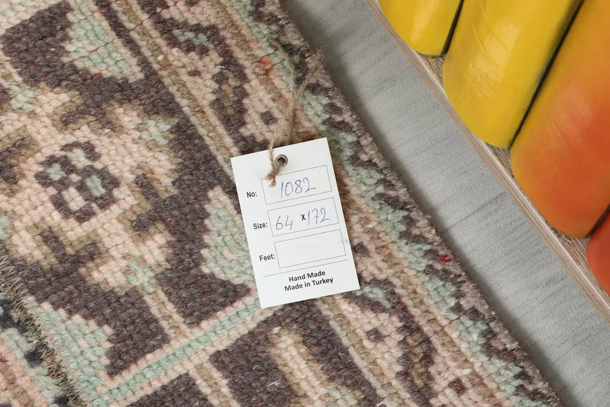 Detail of the rug's texture with a tag displaying 'Hand Made in Turkey' and size