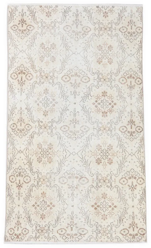 Full top view of the 4x7 ivory and tan floral geometric vintage Anatolian rug on a white background.