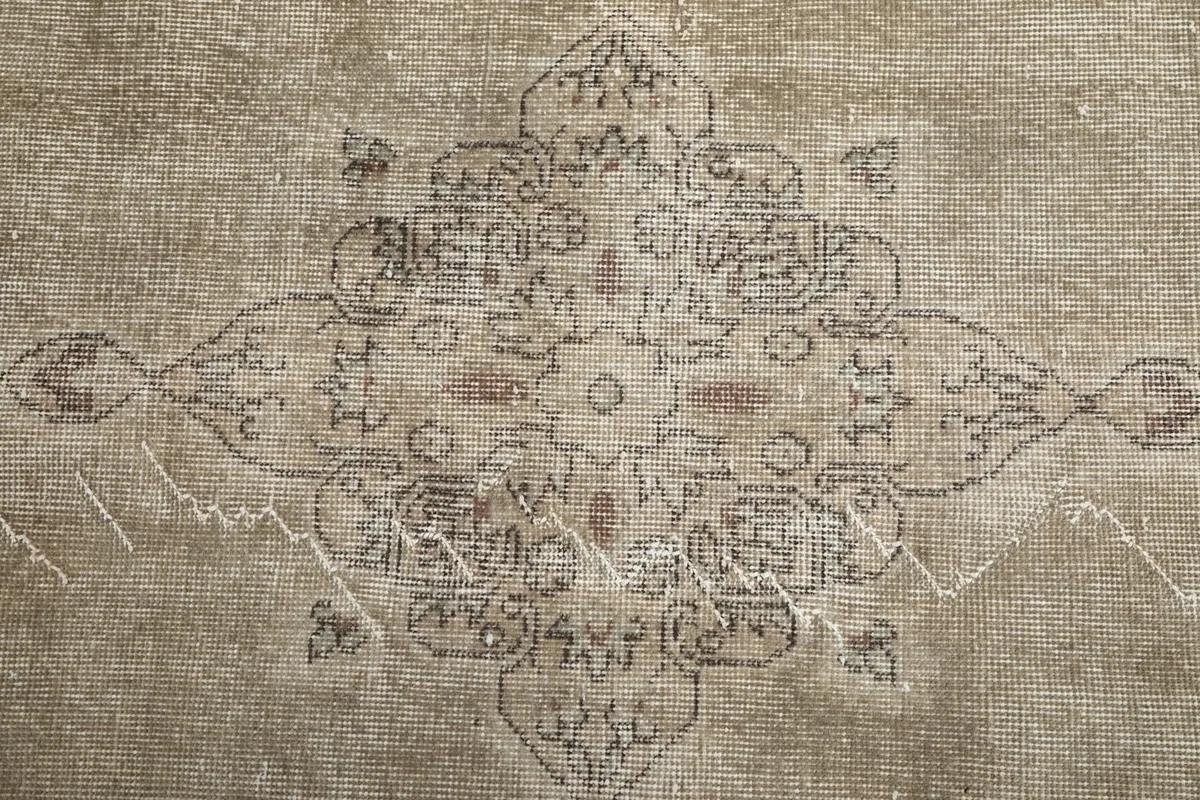Overhead detail of the central medallion and subtle variations in the beige pile