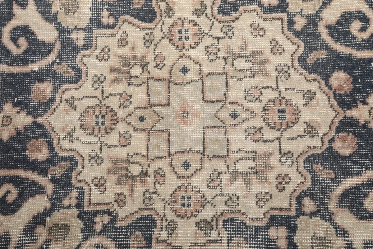 Detailed view of the intricate patterns within the central navy medallion