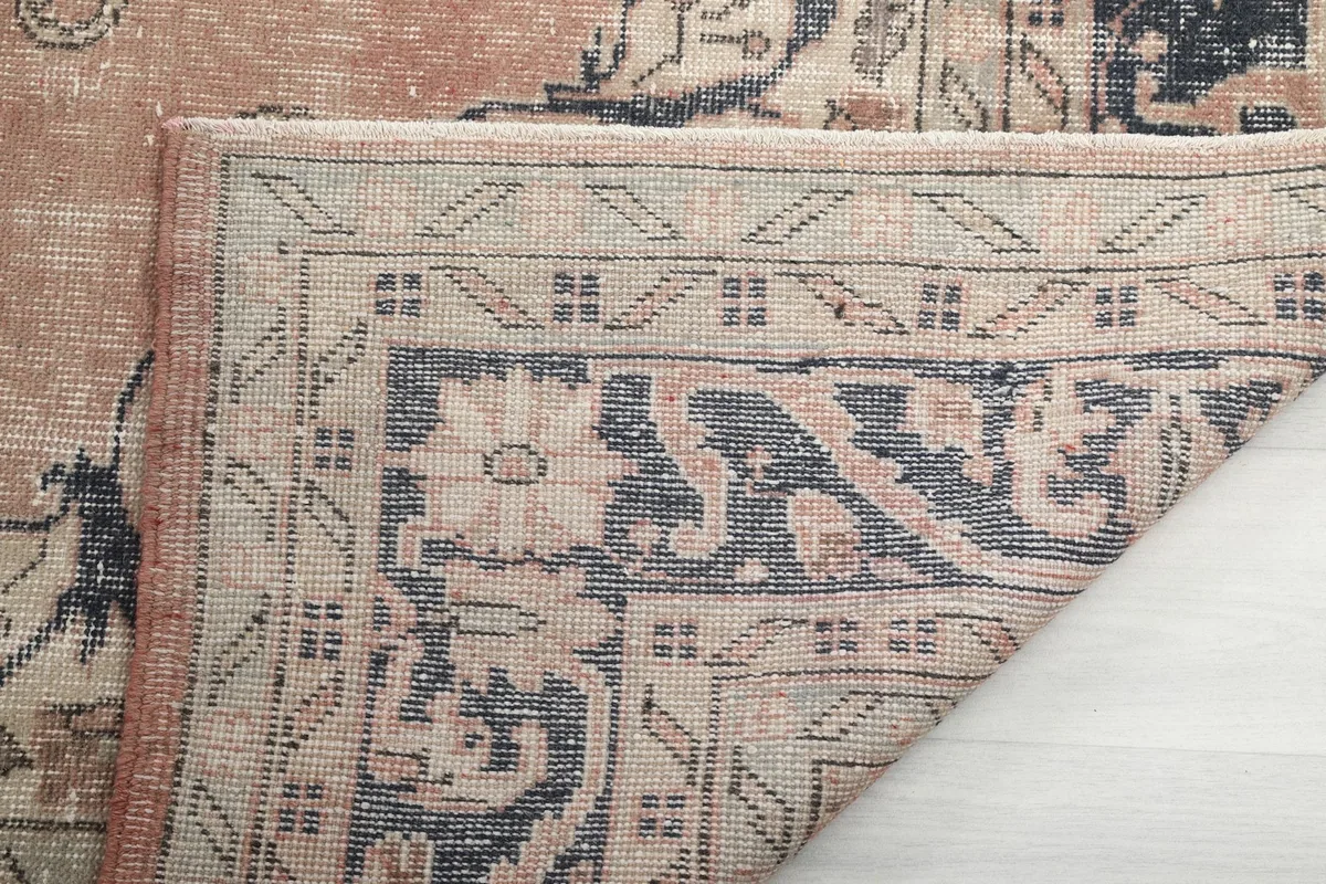 Close-up of the rug's backside, showing the hand-knotted construction and fringe