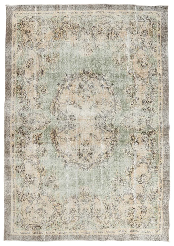 Full top view of the vintage Anatolian area rug with a green field and beige floral medallion