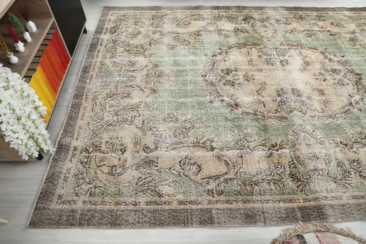 Corner view of the rug, illustrating the distressed look and wool pile texture