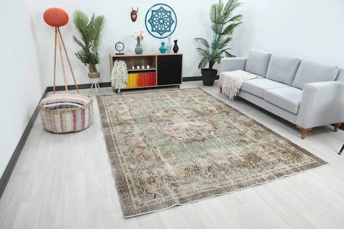 Angled view of the green and beige floral rug in a contemporary living space