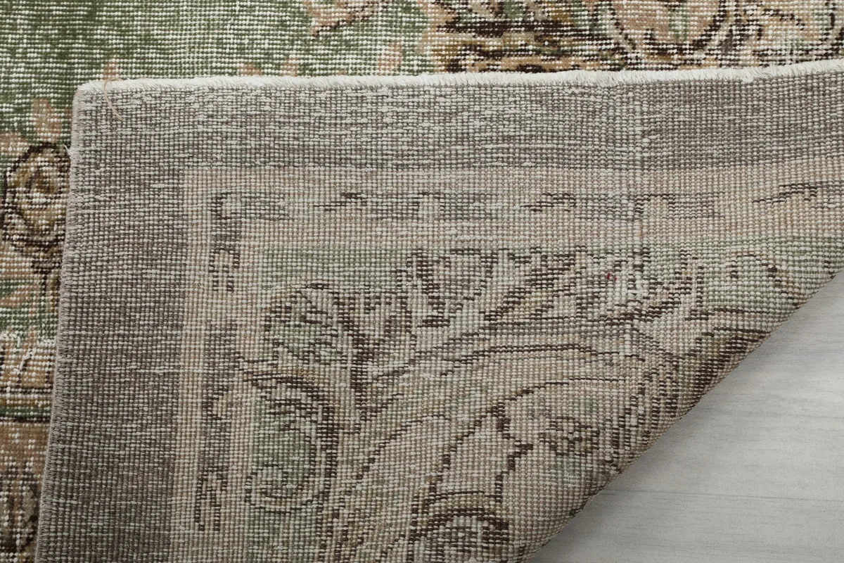 Close-up of the rug's underside, showing the tightly woven cotton foundation and knotting