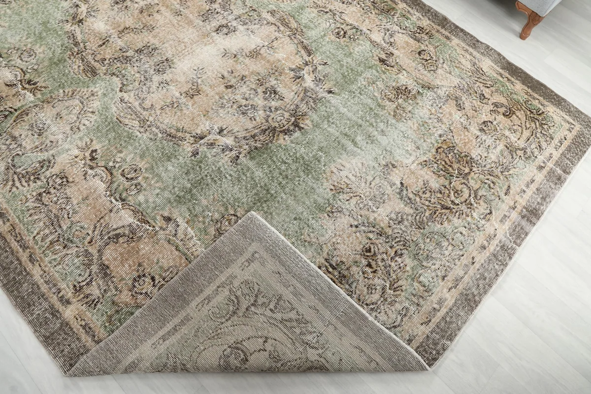 View of the rug folded to reveal the back of the hand-knotted wool pile and cotton foundation