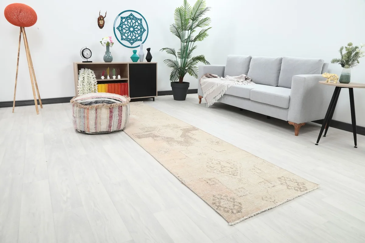 Angled view of the beige runner rug extending across a modern living room space