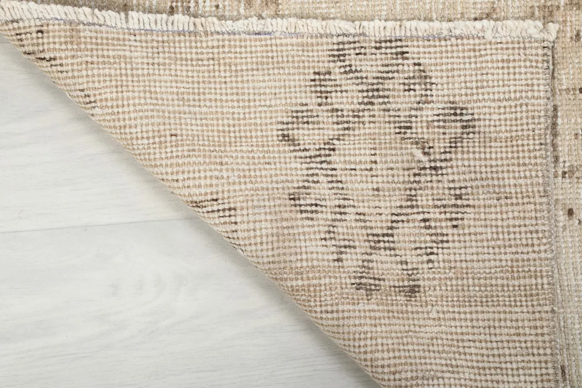 Underside view of the hand-knotted cotton foundation and the back of the wool pile