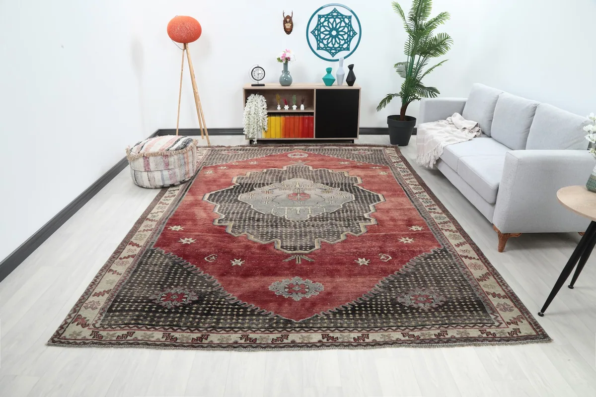 Large red, black, and gray area rug displayed in a living room setting