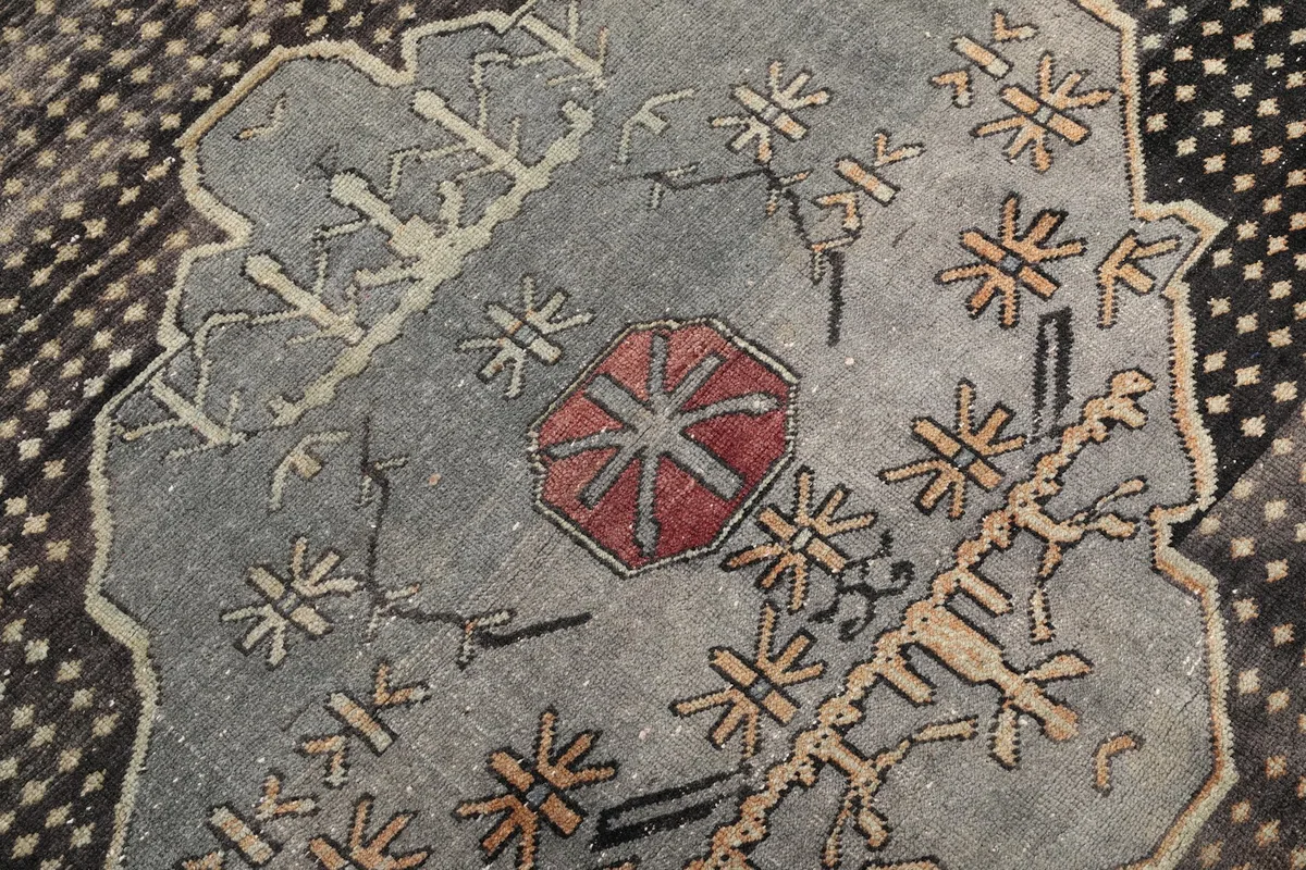 Detailed shot of the intricate patterns within the rug's central medallion