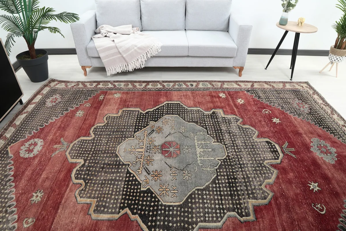 Overhead view of the vintage area rug in a room, highlighting the central medallion