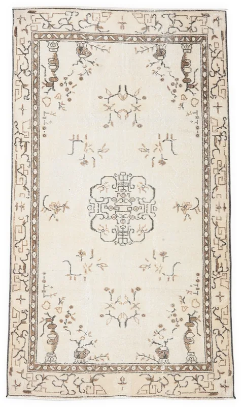 Full overhead view of the 3'10" x 6'8" ivory vintage Anatolian rug on a white background