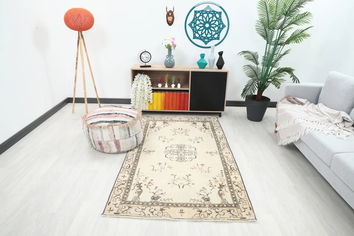 Vintage Anatolian rug in an ivory and brown palette placed in a modern living room setting