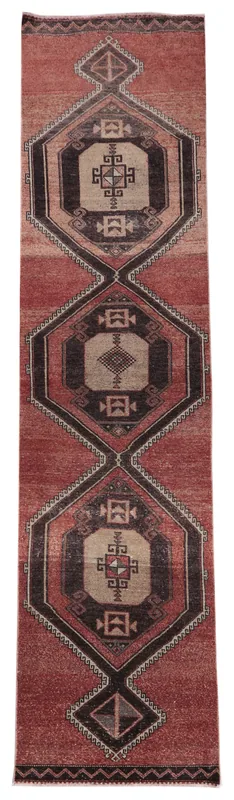 Full top view of the rust vintage Anatolian runner rug with geometric medallion motifs on a white background.