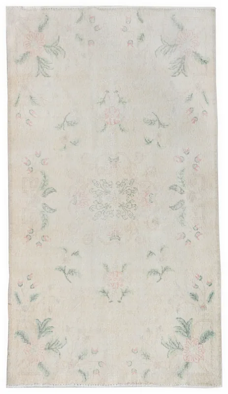 Full overhead view of the ivory, rose, and green floral Anatolian area rug