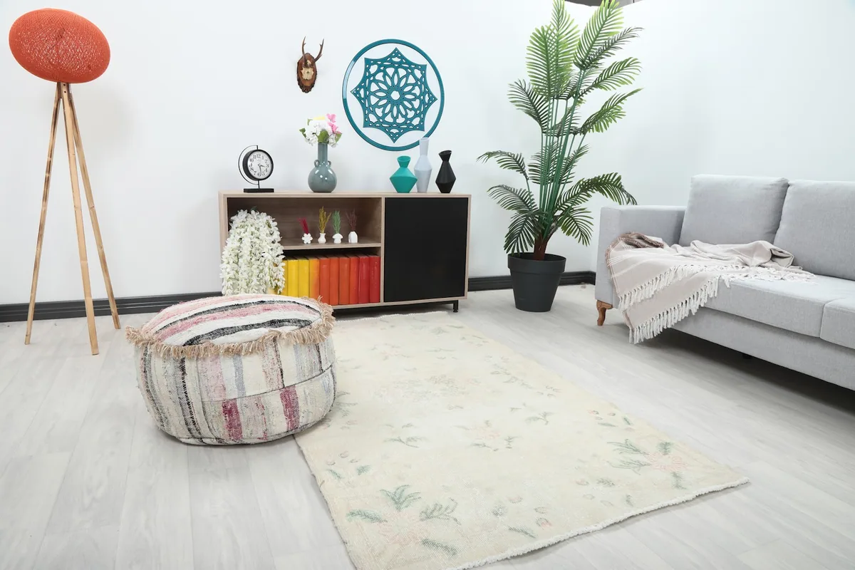 Angle view of the ivory rose green rug in a bright room