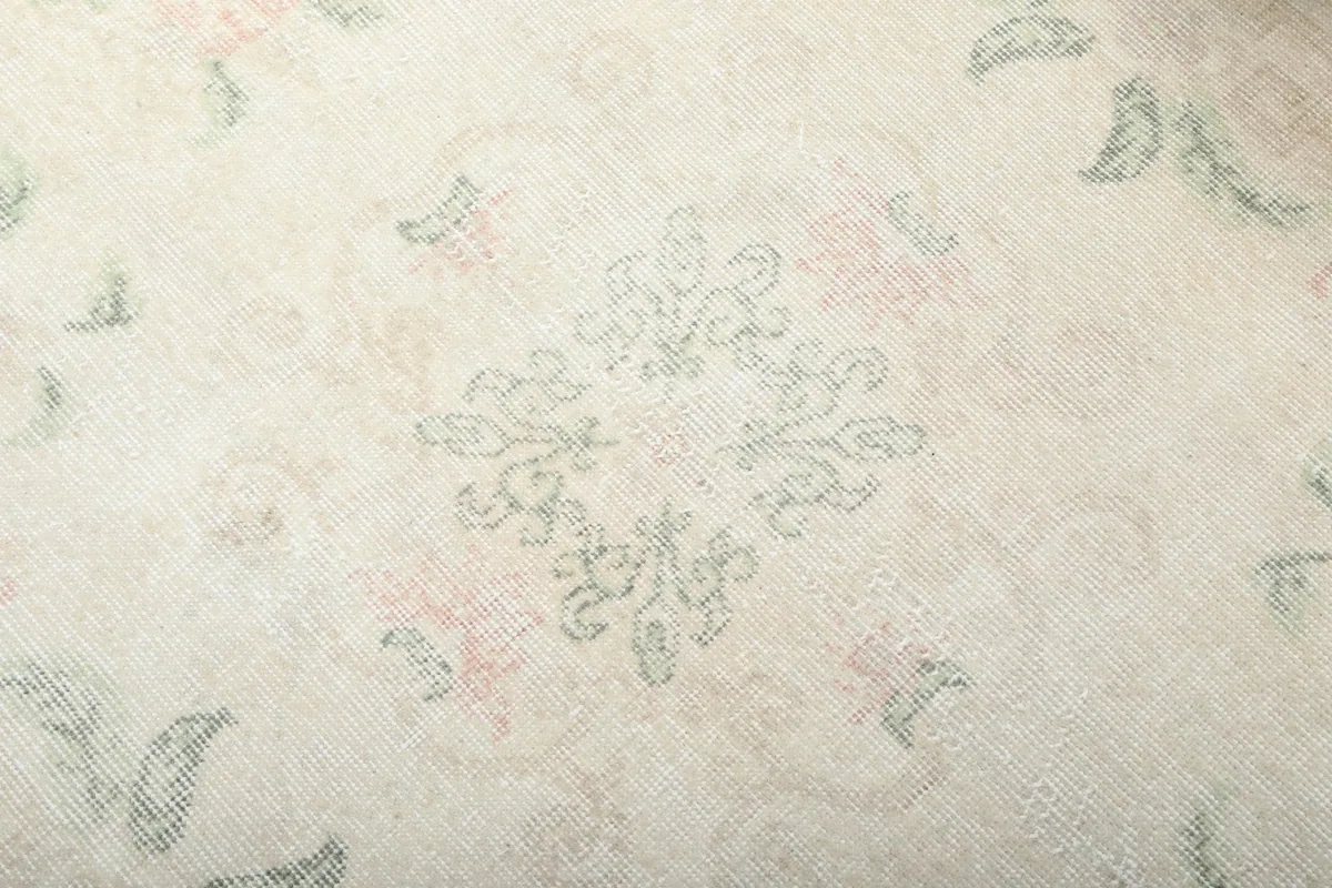 Close-up detail of the central geometric medallion and surrounding floral motifs