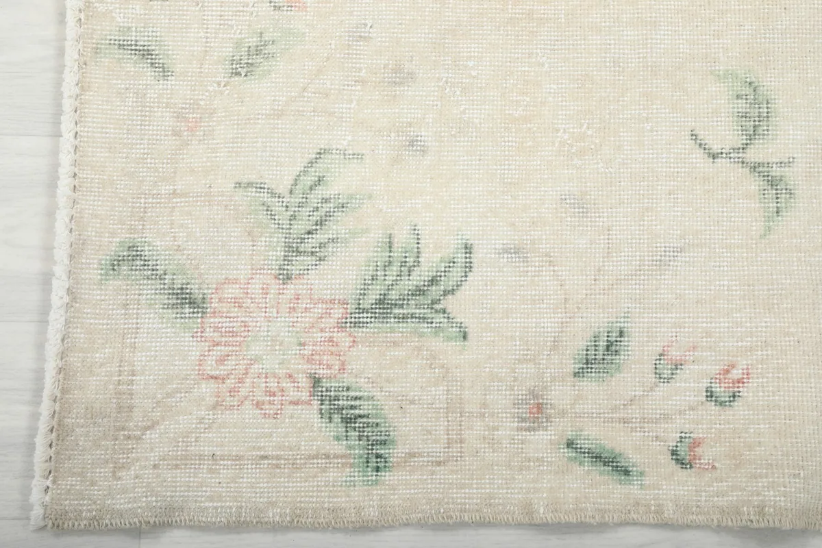 Detail view of the corner floral design and the rug's edge