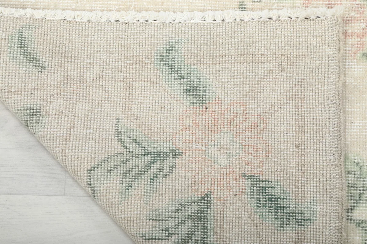 Close-up of the rug's reverse side, revealing the knotting and foundation