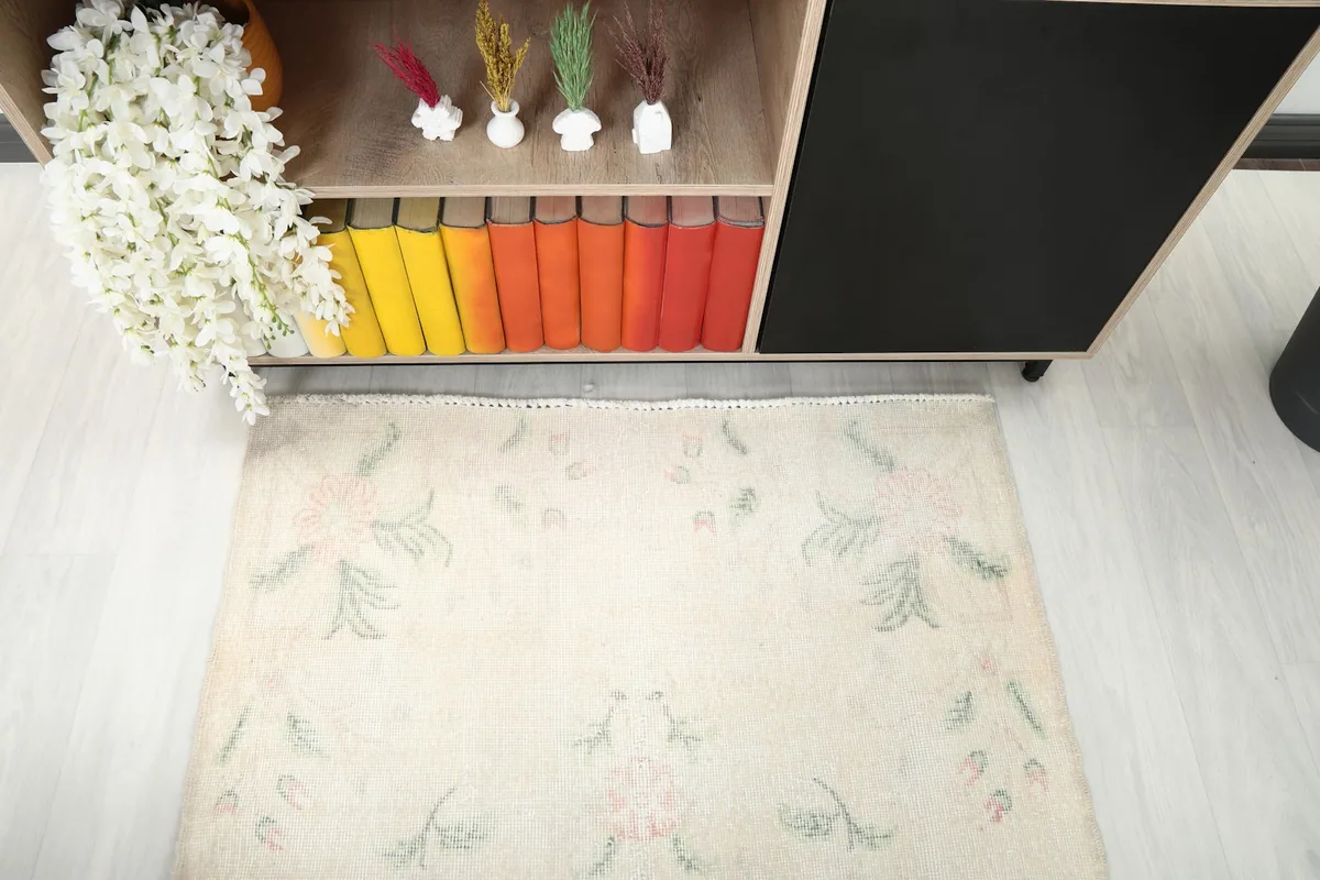 Overhead shot of the rug's top portion, showing border and patterns