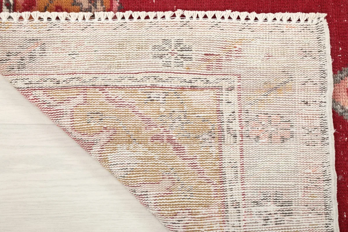 Underside of the rug showing the hand-knotted construction and cotton foundation