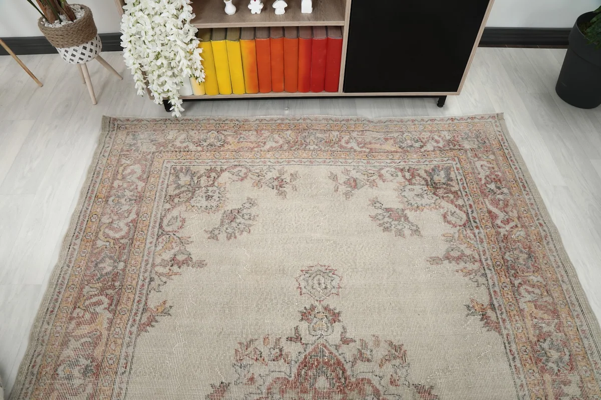 Upper section of the rug, showcasing the floral designs and border from an angle