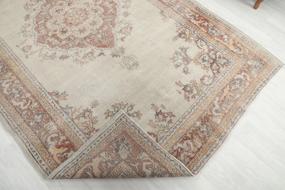 Corner of the rug folded back to show the reverse side of the hand-knotted construction