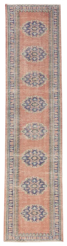 Full top view of the 2'6" x 10'9" rust and blue medallion Anatolian runner on a white background