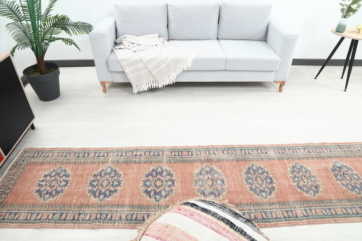 Overhead view of the runner rug extending into a room, highlighting the sequence of blue medallions