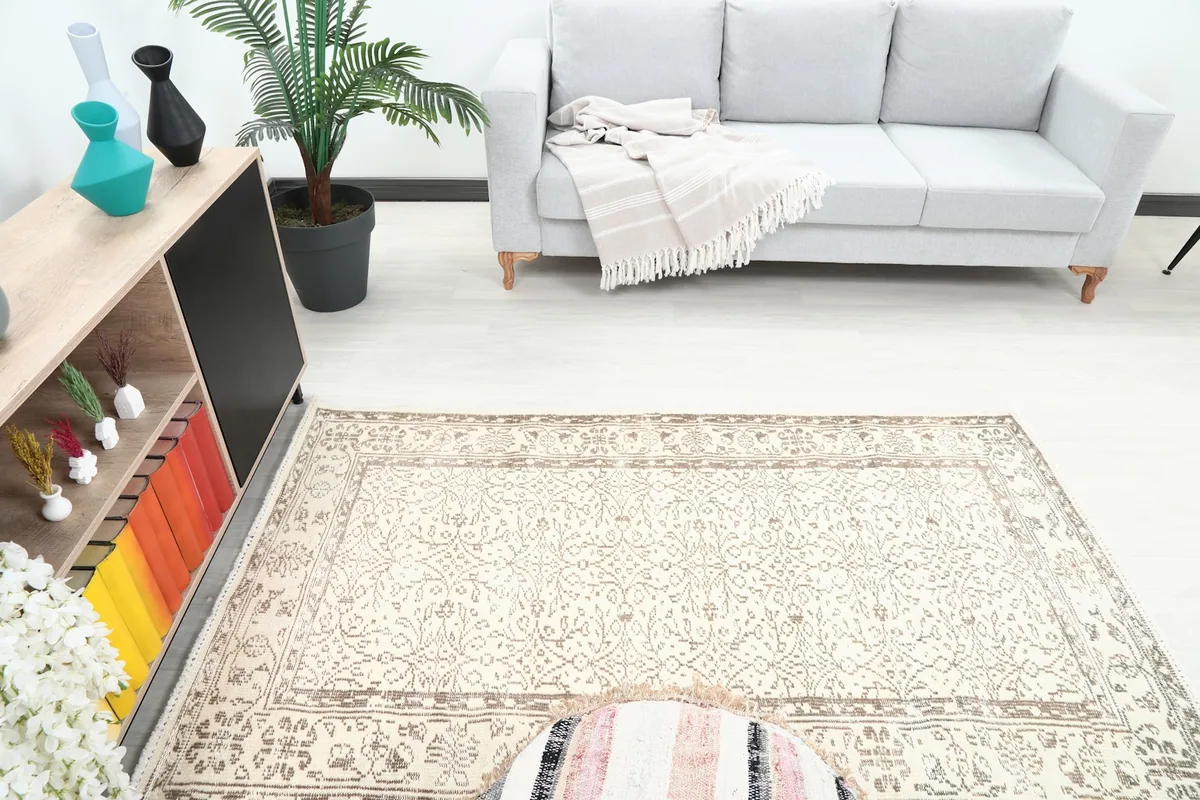 Overhead view of the ivory and tan rug in a room, highlighting its size relative to furniture
