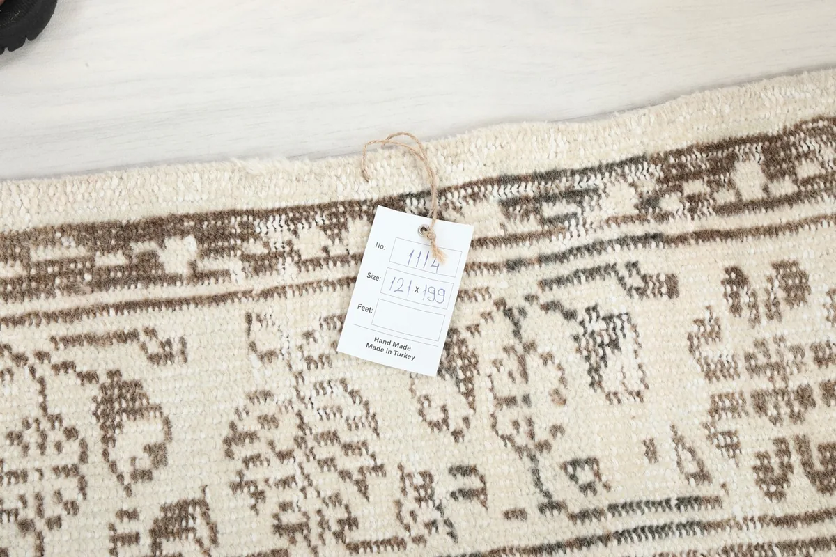 Close-up of the rug's label, displaying its dimensions and origin