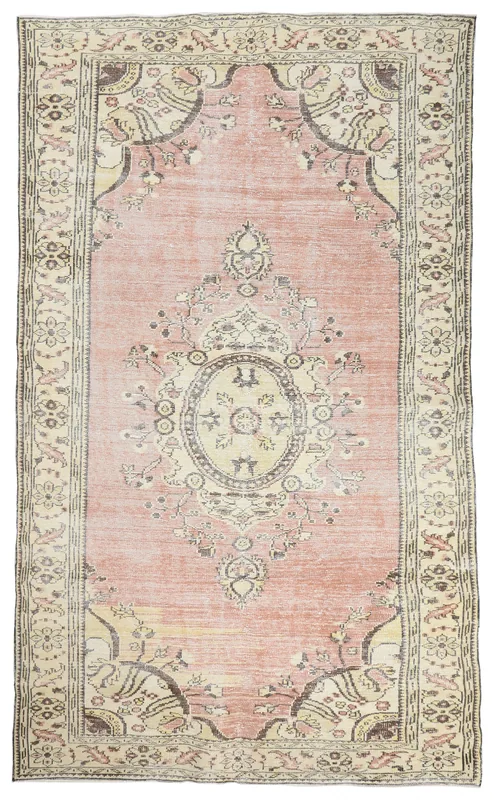 Full top view of the 6'6" x 11'0" vintage Anatolian rose and ivory medallion rug