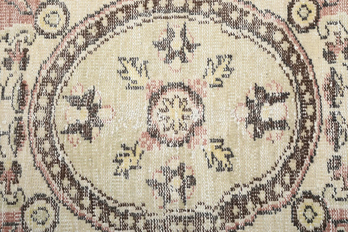 Close-up of the intricate patterns within the ivory central medallion