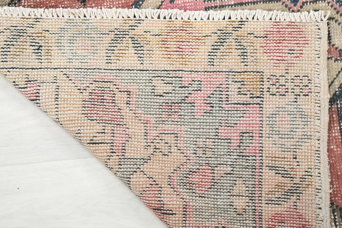 Underside of the rug, revealing the hand-knotted construction and cotton foundation.