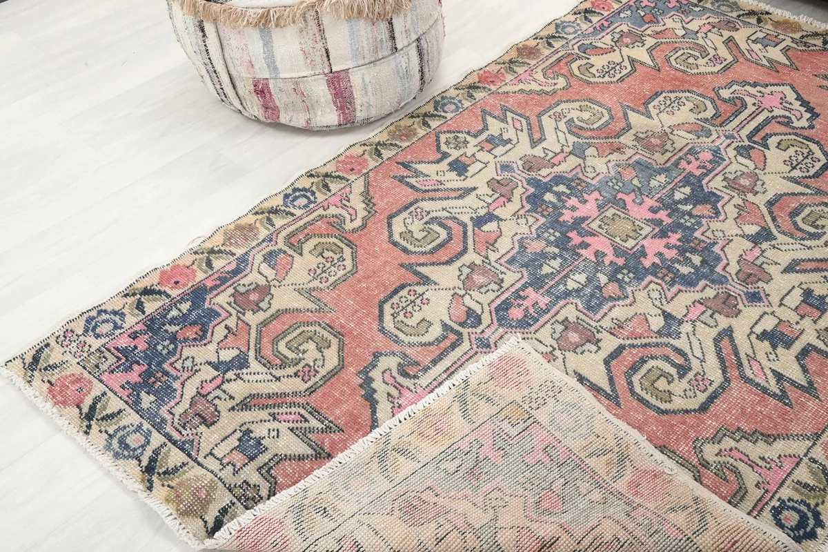 View of the rug folded to show the thickness and texture of the wool pile and cotton foundation.