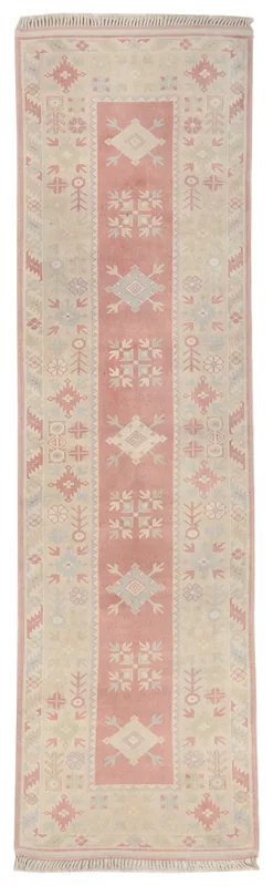 Full overhead view of the 2'9" x 9'11" rose and beige vintage Anatolian runner on a white background.