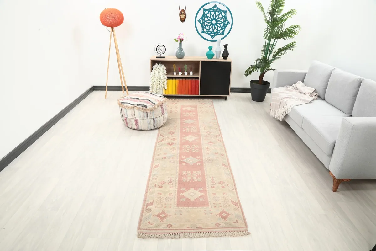 Runner rug displayed in a modern living space with a light gray sofa and wooden accents.