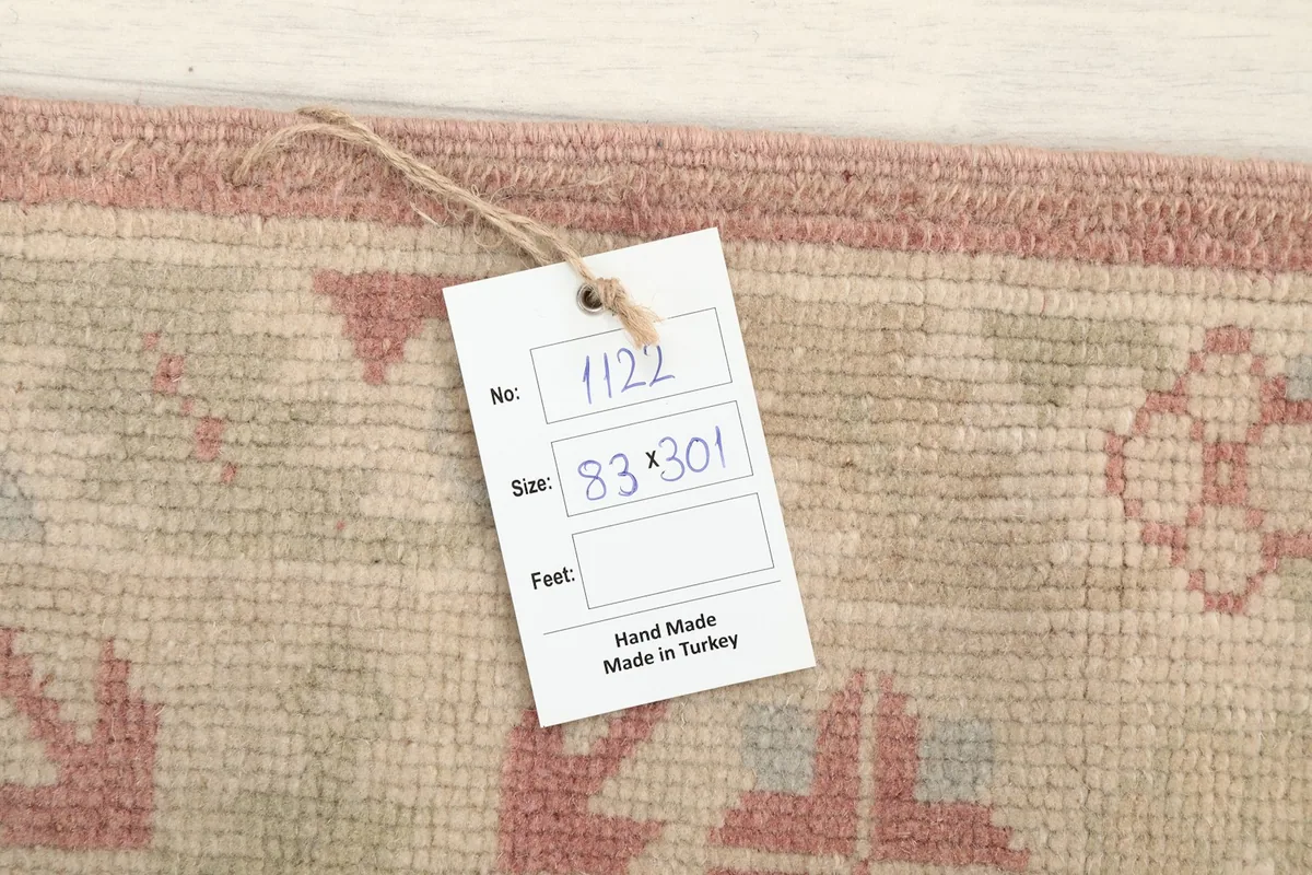 Tag displaying the rug's dimensions in centimeters (83 x 301 cm) and 'Hand Made Made in Turkey'.