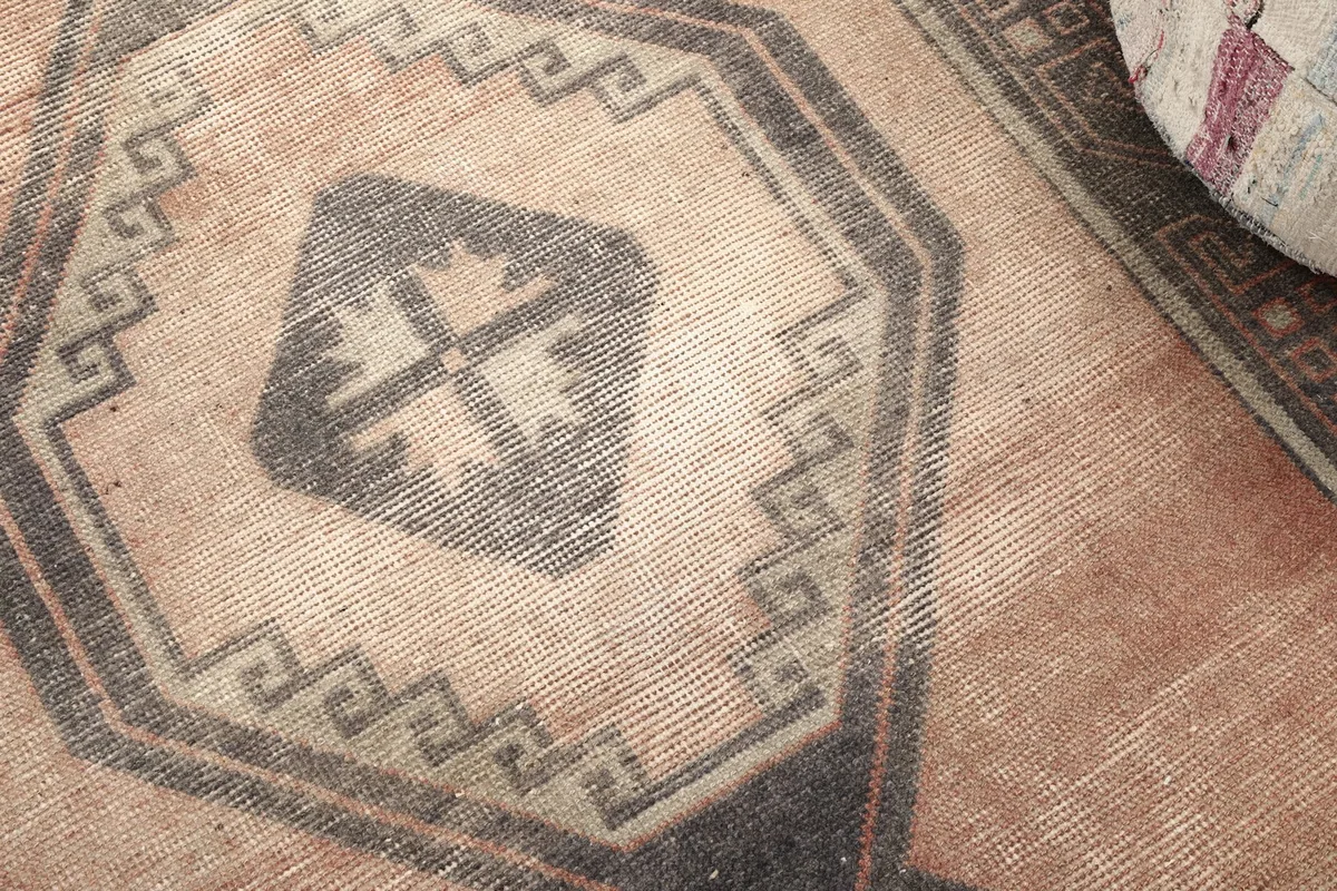 Close up of a central geometric medallion with its intricate patterns and color variations