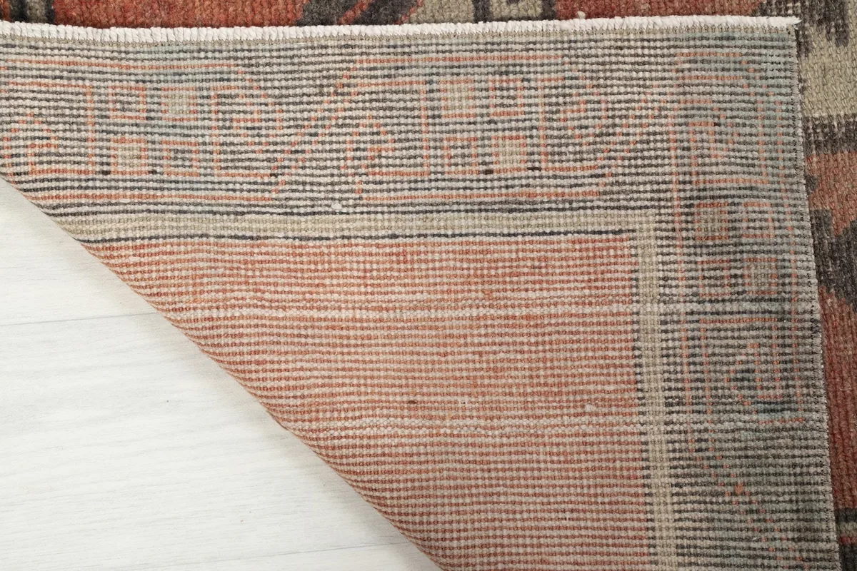 Close up of the back of the rug, revealing the hand-knotted cotton foundation
