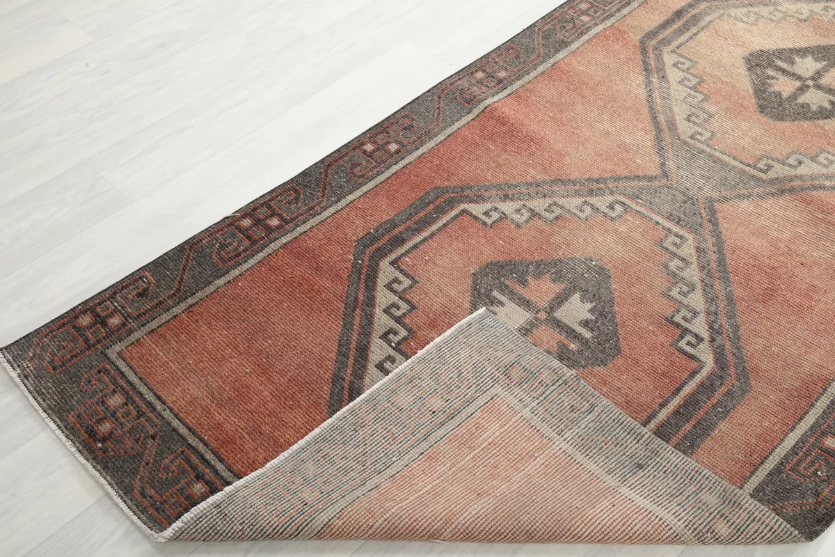 View of the rug folded back, showing the wool pile and cotton foundation