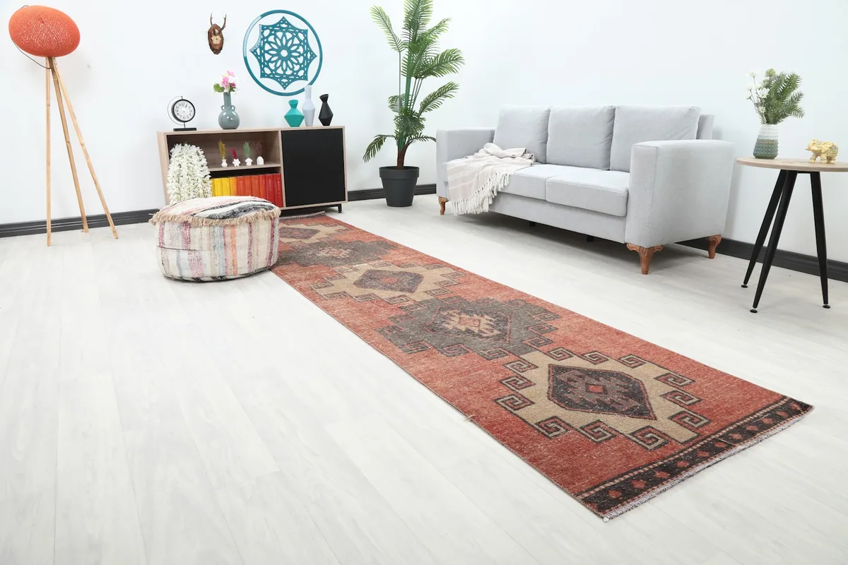 Angle view of the rust geometric runner in a modern hallway, highlighting its placement and design.