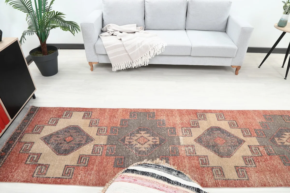 Overhead view of the runner in a room, capturing the full pattern and color scheme of rust, tan, and charcoal.