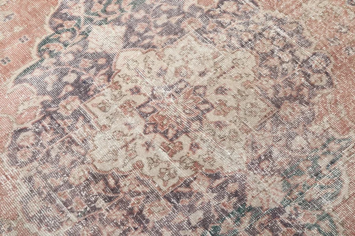 Close-up of the rug's wool pile and intricate patterns within the central medallion