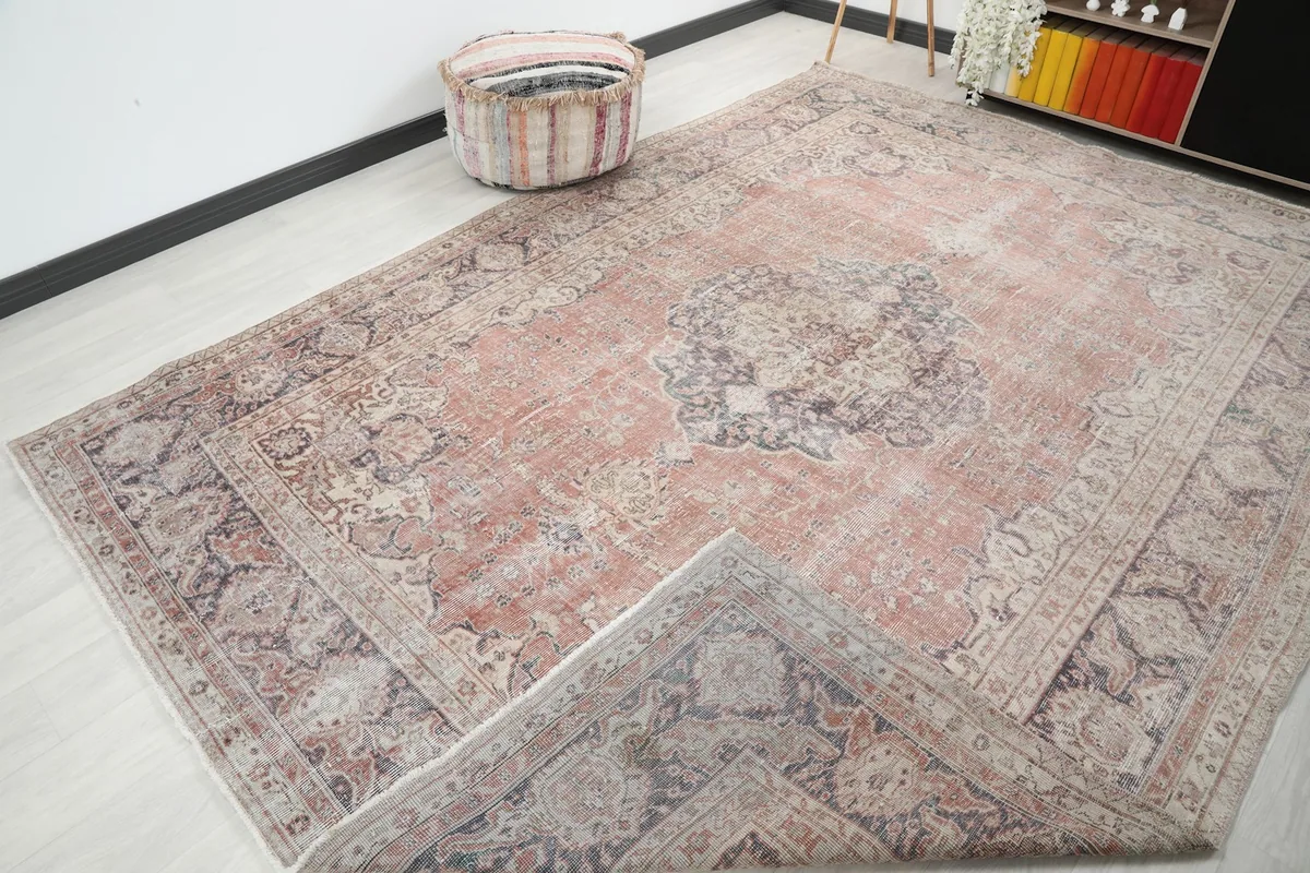 View of the large rose rug with a corner folded back, showing the cotton foundation
