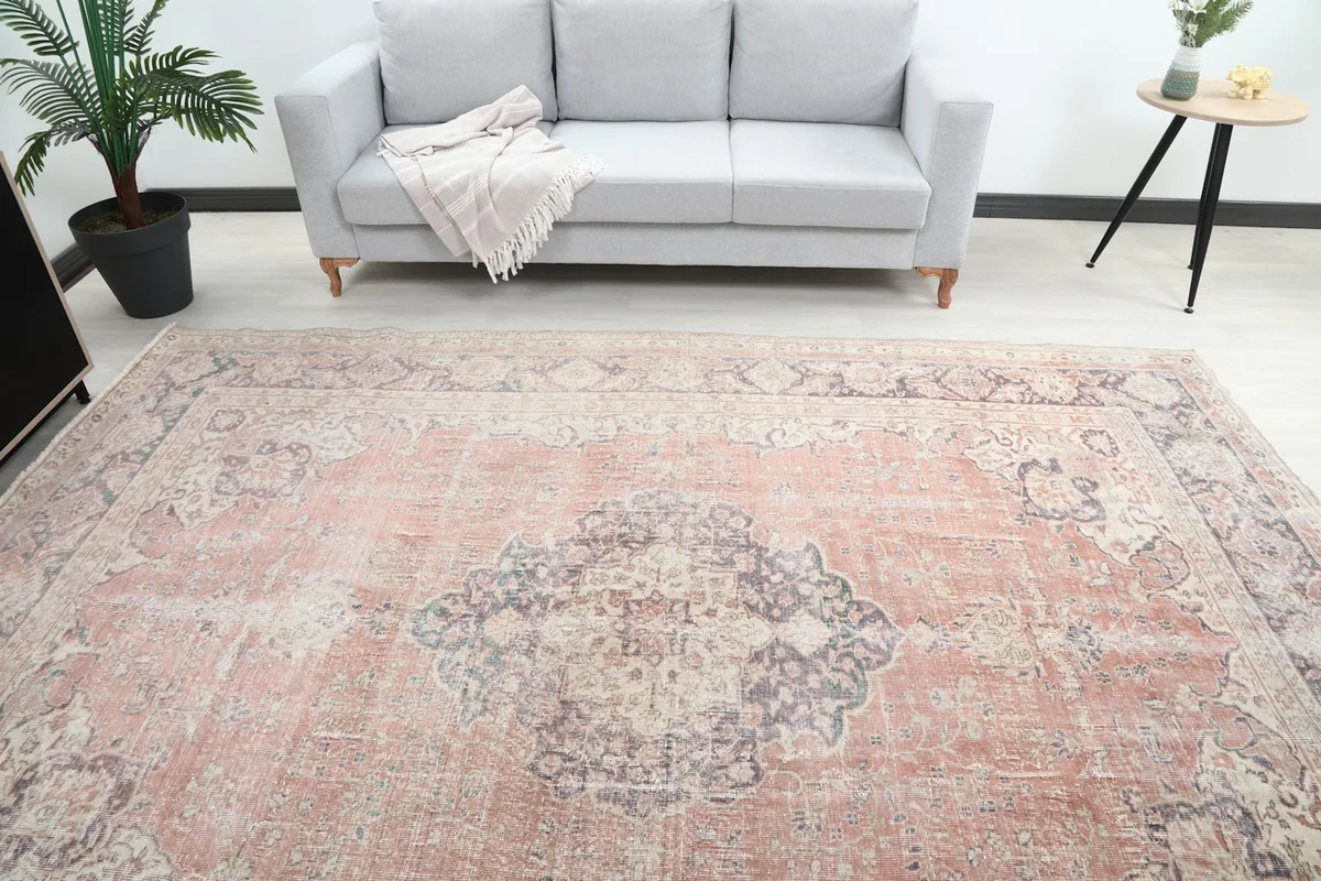 Overhead view of the rose area rug in a room, highlighting the central medallion and color variations
