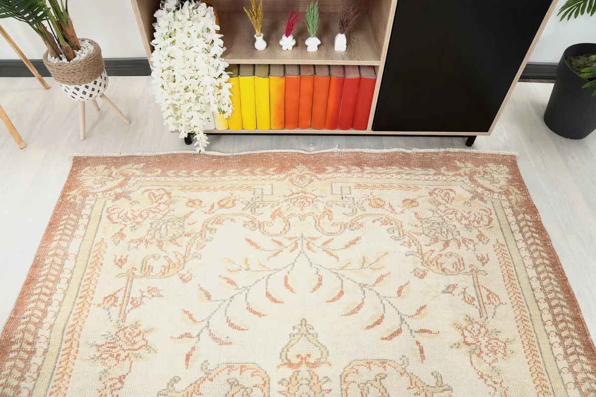Detail view of the rug's top section and border, showing the floral motifs