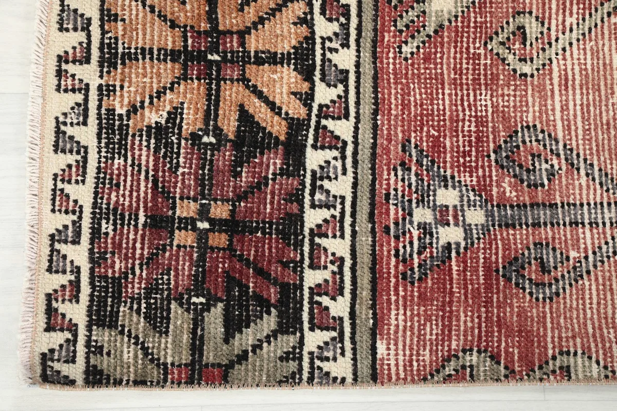 Close-up of the border design and fringe on one end of the Anatolian runner rug
