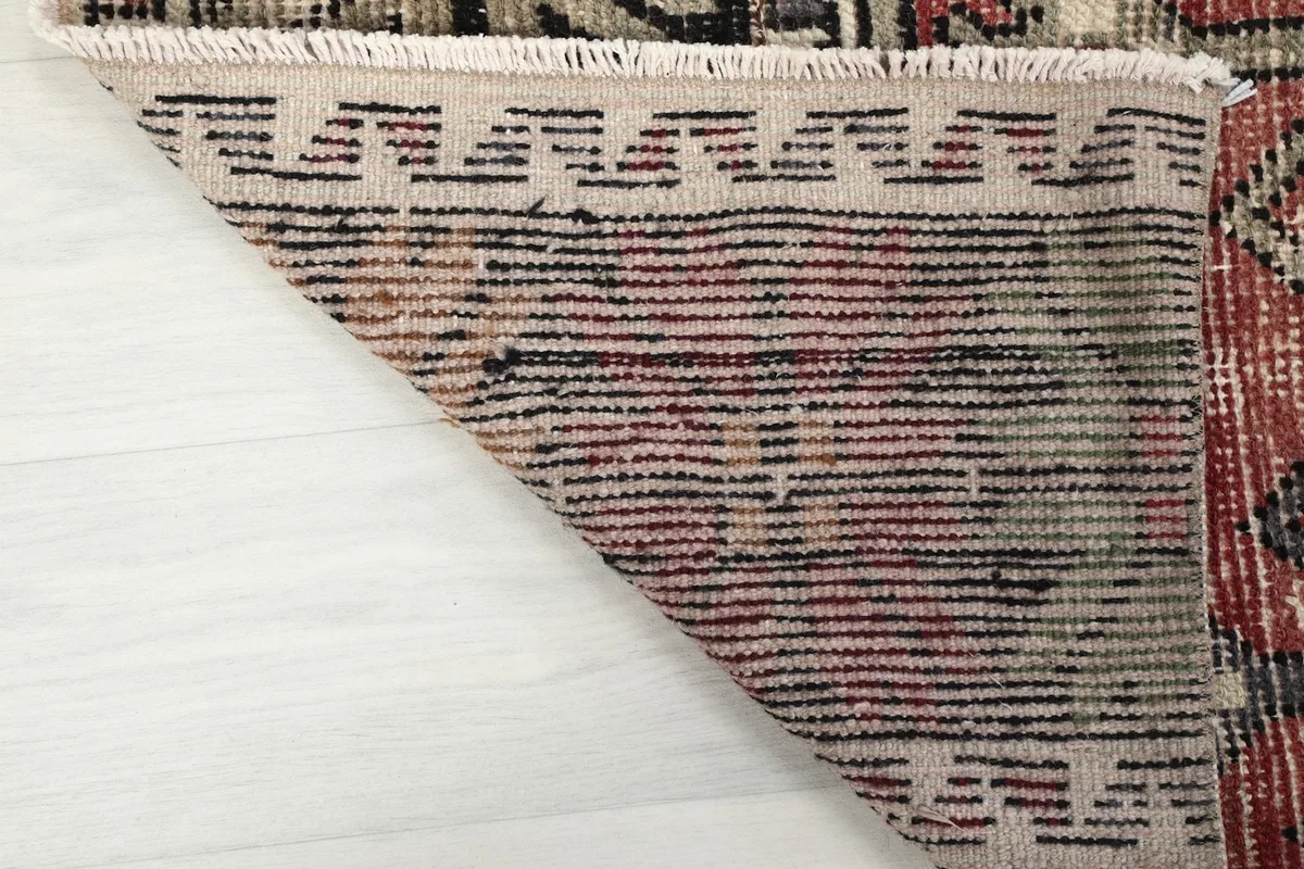 Close-up of the back of the hand-knotted rug, revealing the cotton foundation and knotting