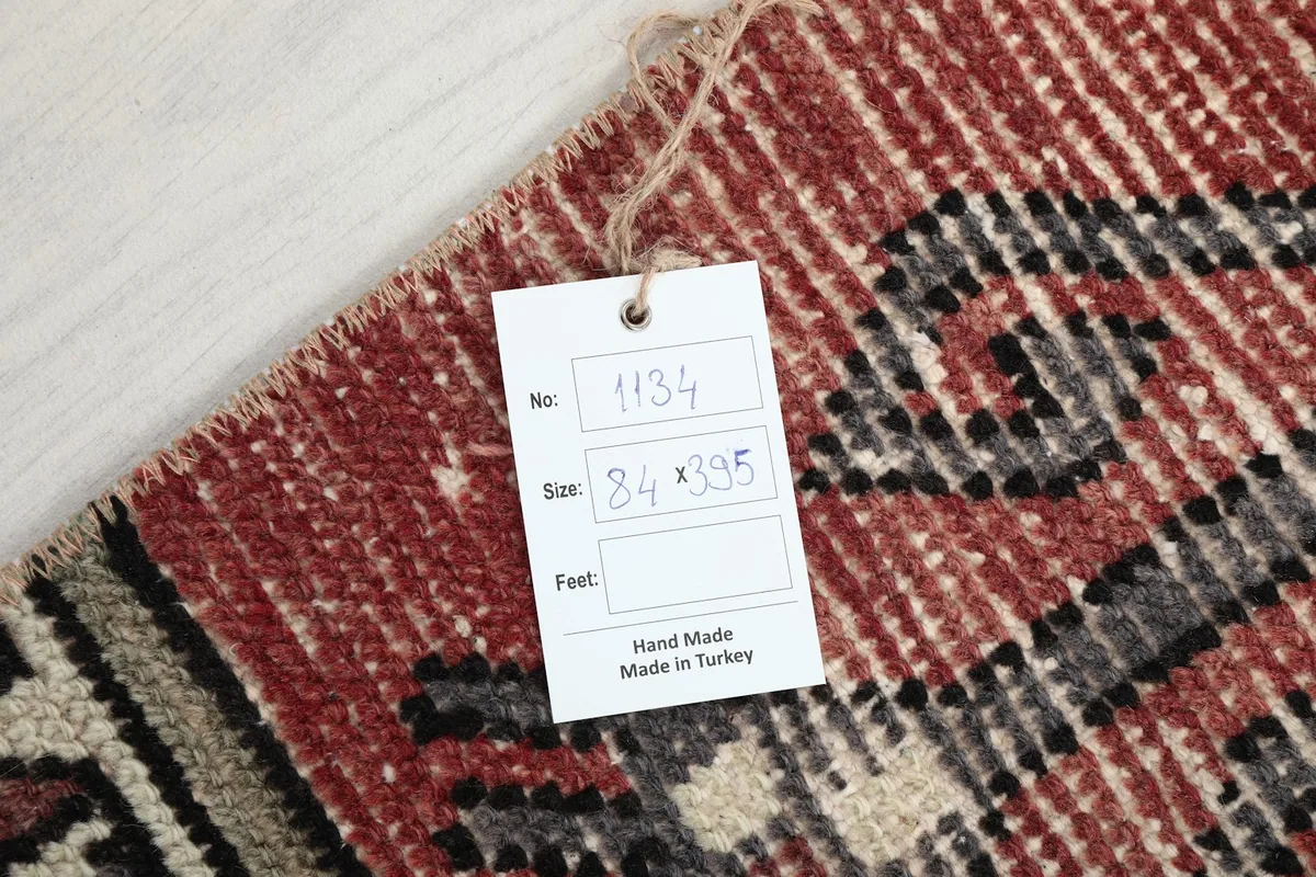 Tag showing the rug's unique number and size in centimeters, confirming handmade origin